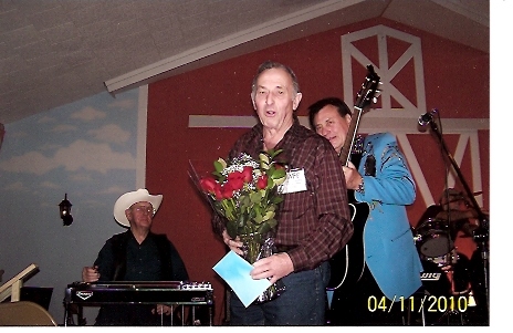 Norm Poulin (the producer) of the Pioneer Show for 25 years receives roses